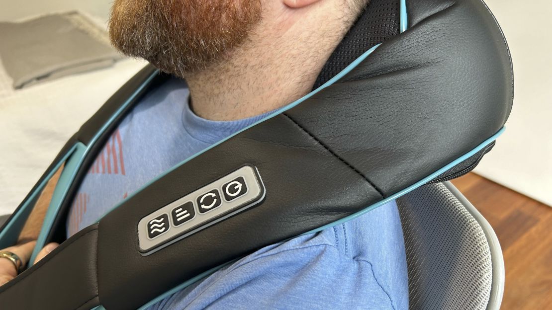 CNN Underscored editor Rick Stella wearing a neck and back massager.