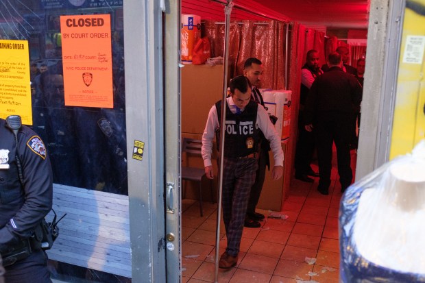 Police raid a suspected brothel on Roosevelt Avenue and 95th Street in Corona, Queens, New York City on Thursday, Jan. 25, 2024. (Gardiner Anderson for New York Daily News)